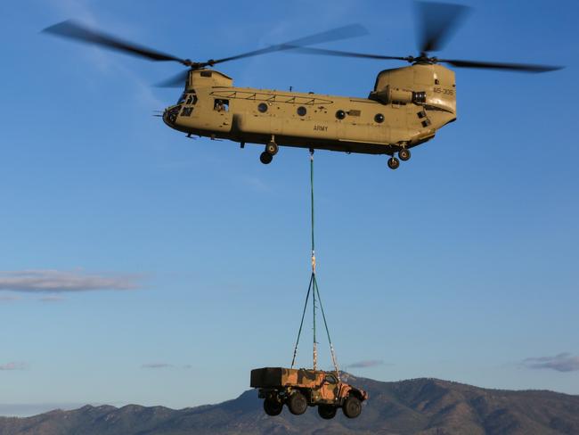 Australian Army CH-47F Chinook takes the weight of the Hawkei Protected Mobility Vehicle while conducting external lift trials. *** Local Caption *** From 26-30 June 2017, external lift trials were conducted with an Australian Army CH-47F Chinook, and the two-door and four-door variants of the Hawkei Protected Mobility Vehicle (PMV). Held at RAAF Base Townsville, the trials assessed the practice and techniques required to safely attach and carry the Hawkei, which weighs approximately nine tonnes. The trials were conducted by the Capability Acquisition and Sustainment Groupâs Land 121 Phase 4 project team and Air Mobility Training and Development Unit (AMTDU), a joint Army and Air Force unit tasked with establishing air load techniques for new equipment and vehicles, and training personnel in this practice.  AFIR: 000-219-750