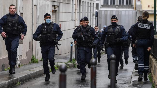 French police rush to the attack scene in Paris. Picture: AFP