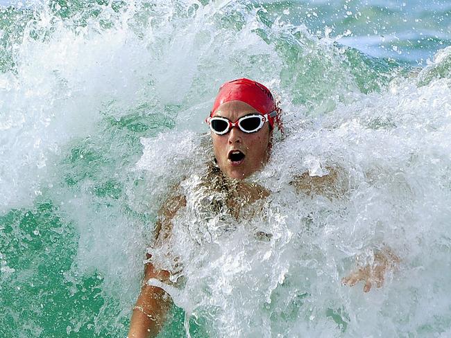 Swimmers come ashore in the 1km race at Bondi. Picture: John Appleyard