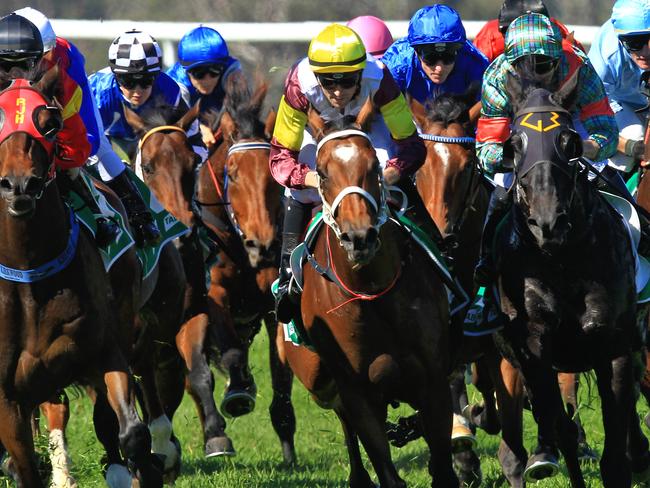 Loving home ridden by Tye Angland (yellow cap, maroon with yellow armbands) wins race 1 during Scone Races located in the Upper Hunter Region of NSW. The Bend . Pic Jenny Evans