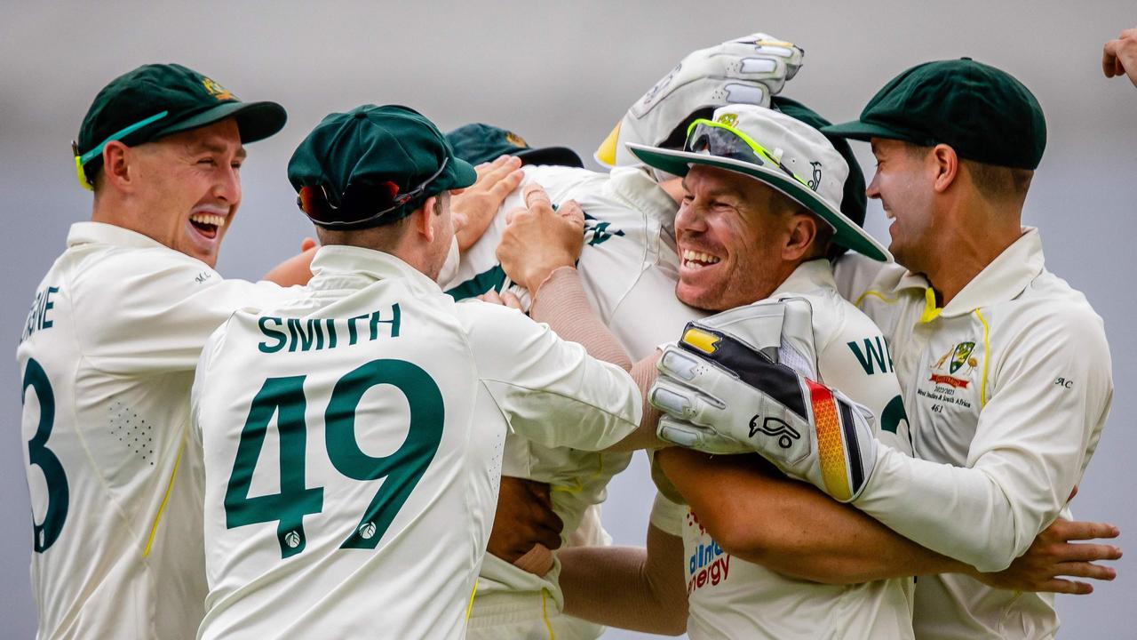 Australia's players celebrate. Photo by Patrick HAMILTON / AFP