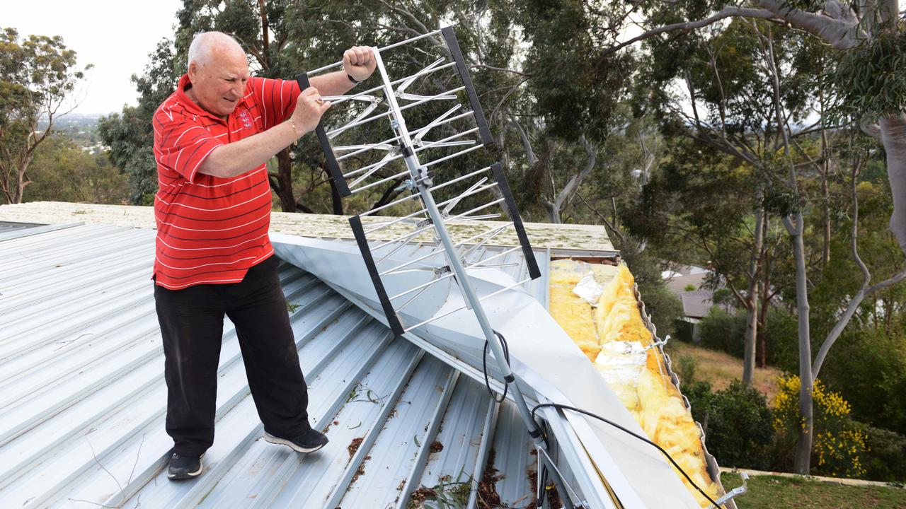 Mario Petruzzelli of Mitcham looks at his damaged roof. Picture: AAP / Brenton Edwards