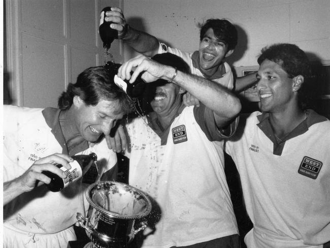 Andrew Sincock, David Hookes and Joe Scuderi pouring beer into trophy after winning the SACA West End One Day Cup in 1991.