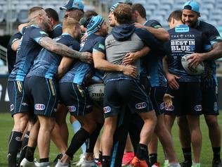 New South Wales Blues players jokingly huddle together during their Captains Run training session, ahead of State of Origin II against the Queensland Maroons at ANZ Stadium in Sydney, Tuesday, June 20, 2017. (AAP Image/David Moir) NO ARCHIVING