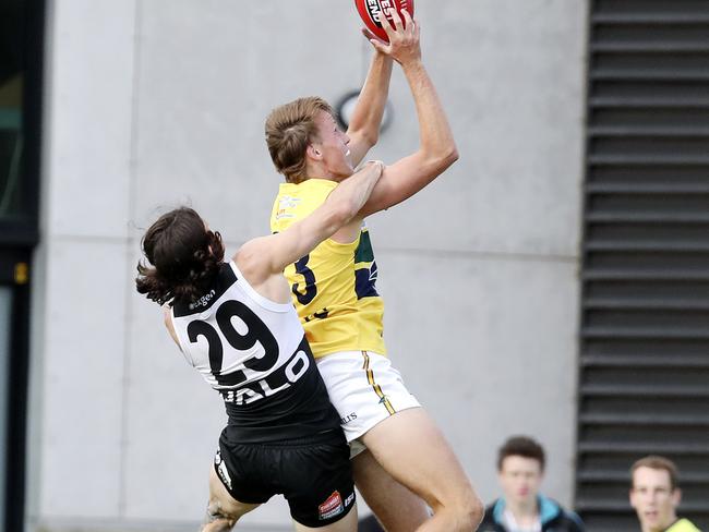 14/04/18 - SANFL - Port Adelaide v Eagles at Alberton Oval. Jack Lukosius takes a big mark over Jasper Pittard and Jimmy Toumpas.  Picture SARAH REED