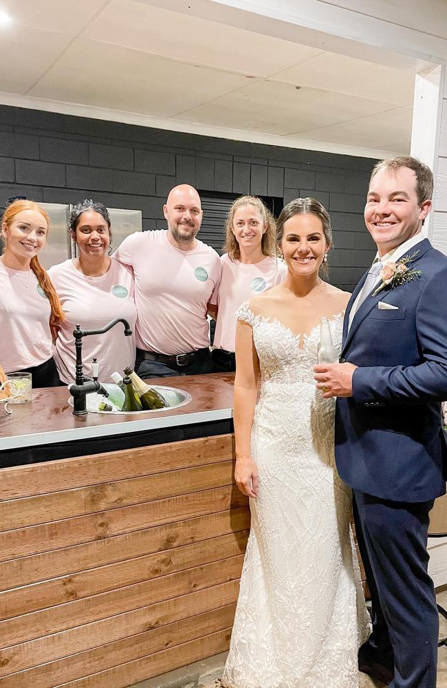 Michelle Ludwig, second from left, with The Lookout Woodbury staff and a happy bride and groom.