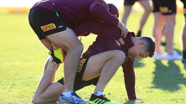 Billy Slater gets a stretch before training. (Adam Head)