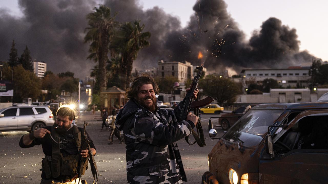 People shoot in the air as they celebrate the fall of the Syrian government in Damascus, Syria, Sunday, Dec. 8, 2024. (Ugur Yildirim/Dia Photo via AP)