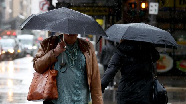 Adelaide pedestrians try to keep dry as Adelaide is hit with rain. Picture: NCA NewsWire / Kelly Barnes/File