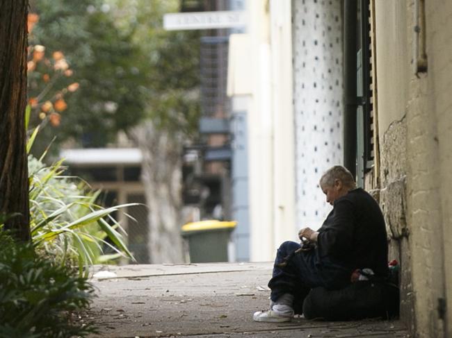 Generic Homeless Photo.Older unidentified homeless woman sits alone in the back streets of Redfern Sydney.Photo: Tim Pascoe