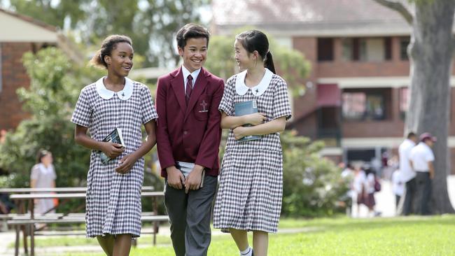 Chidinma Nwanoka, 12, Kyle Candelaria, 12, and Jasmine Fadeli, 12, at Holy Spirit Catholic College in Lakemba. Picture: Justin Lloyd.