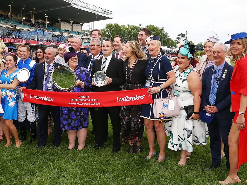 Jockey Hugh Bowman (left) and trainer Chris Waller with the trophy and connections.