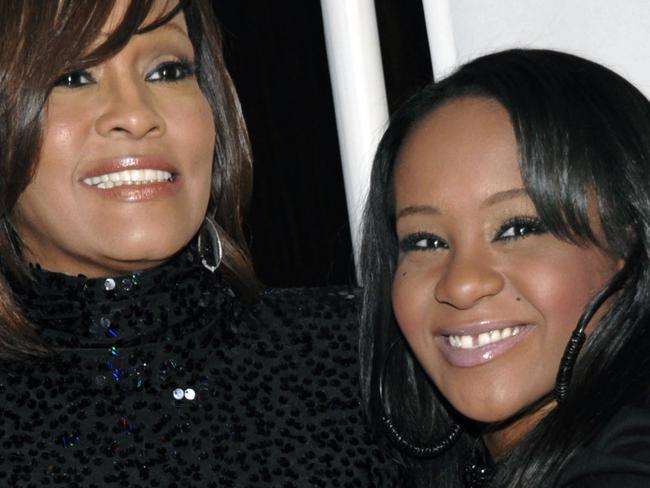 FILE - In this Feb. 12, 2011, file photo, singer Whitney Houston, left, and daughter Bobbi Kristina Brown arrive at an event in Beverly Hills, Calif. Brown is moving to hospice care after months of receiving medical care. Pat Houston says in a statement Wednesday, June 24, 2015, that Whitney Houston’s daughter’s “condition has continued to deteriorate. Brown was found face-down and unresponsive in a bathtub of her Georgia home earlier this year. She underwent surgery to replace her breathing tube with a tracheostomy tube in February. (AP Photo/Dan Steinberg, File)