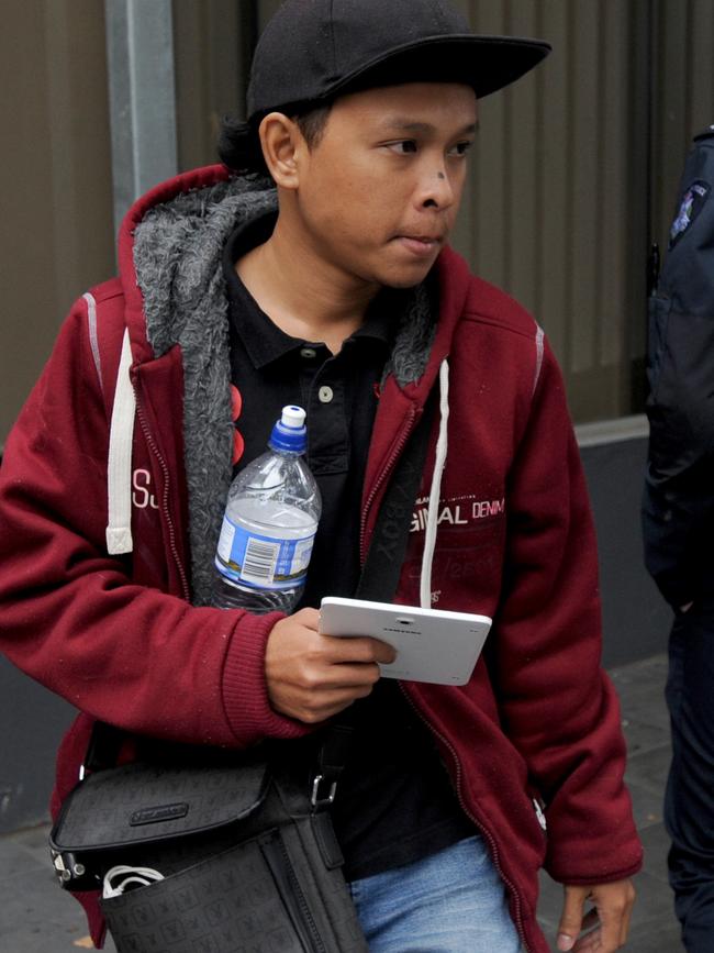 The husband (name unknown) of Siti Kamal leaves Ringwood Magistrates’ Court. Picture: Andrew Henshaw