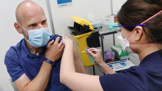 Victoria’s Covid-19 commander, Jeroen Weimar, gets his booster shot. Picture: David Crosling