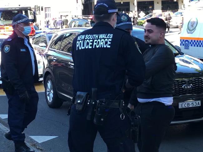 Police apprehending one man after clashes outside Victoria Park.