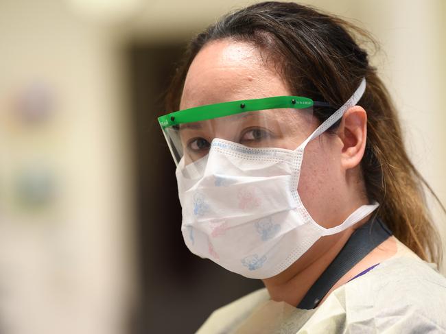 Healthcare worker Vanessa Chang poses for a photo in the Coronavirus screening clinic at Cabrini private hospital in Melbourne, Tuesday, March 31, 2020. Private hospitals will provide more than 100,000 health professionals and 34,000 beds to boost the nation's medical resources to deal with the COVID-19 crisis. (AAP Image/James Ross) NO ARCHIVING