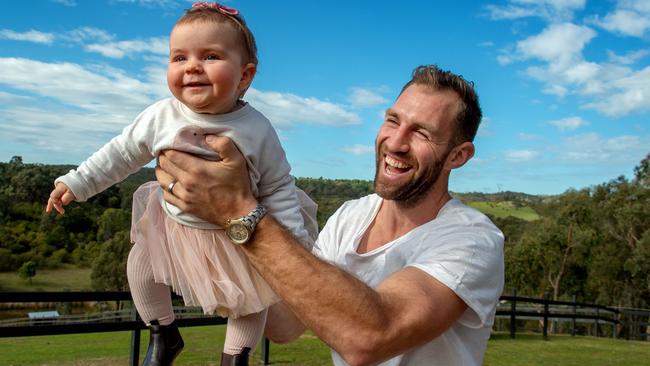 Travis Cloke with his daughter, Scarlett, (9 months) on their Kangaroo Ground property. Picture: Jay Town