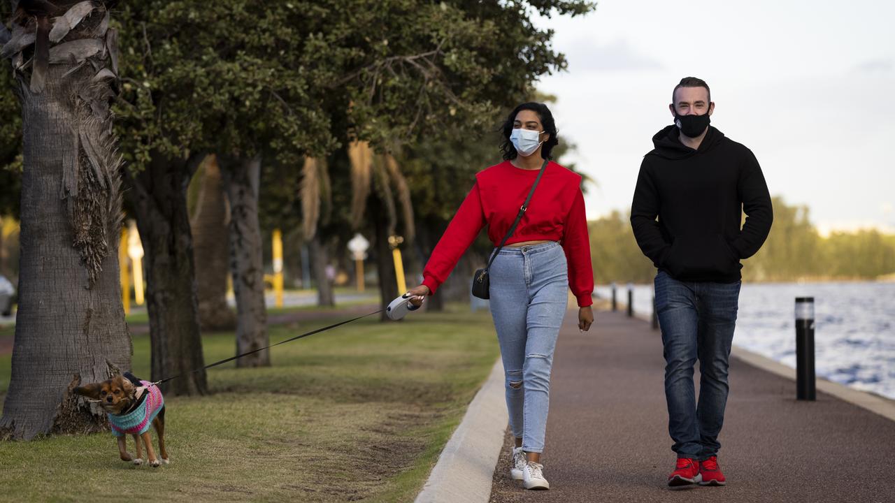 A Perth couple walk their dog during lockdown. Picture: Matt Jelonek/Getty Images