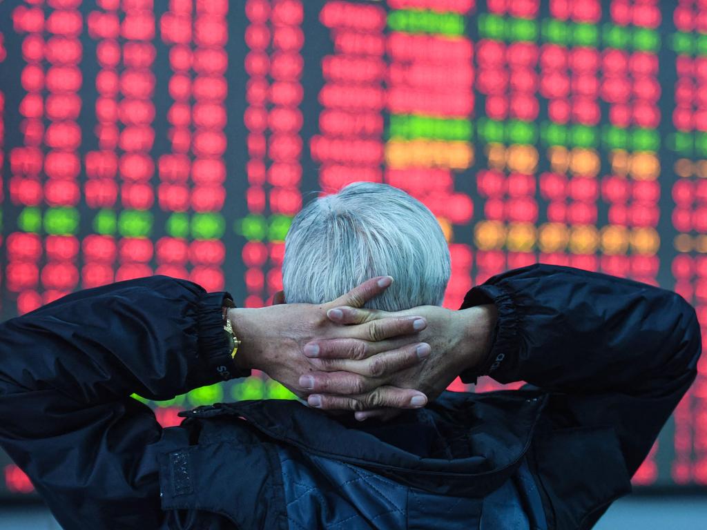 An investor looks at a screen showing stock market movements at a securities company in Hangzhou, in eastern China's Zhejiang province. Picture: AFP