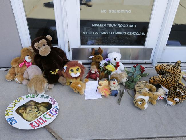 United in grief ... Stuffed animals and notes lie outside Dr. Walter James Palmer's dental office in honour of Cecil. Picture: AP