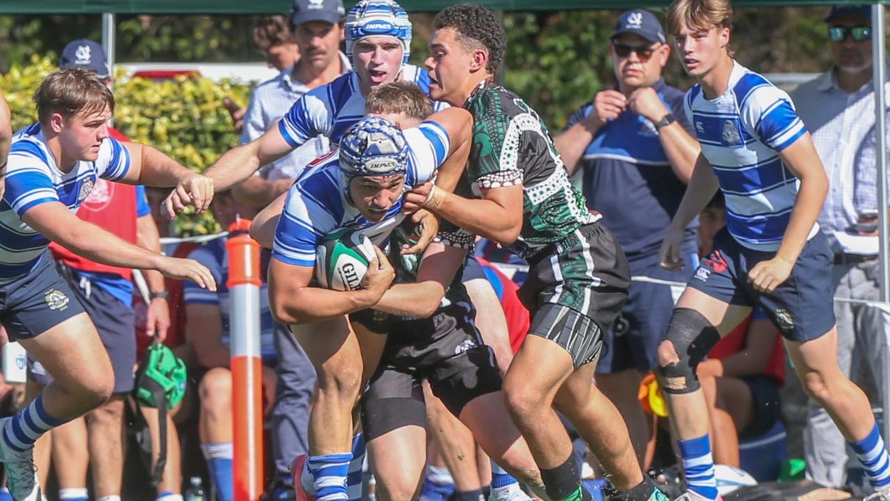 Tai Taka tackles (right in the green jersey). GPS First XV rugby between Nudgee College and BBC. Photos by Stephen Archer