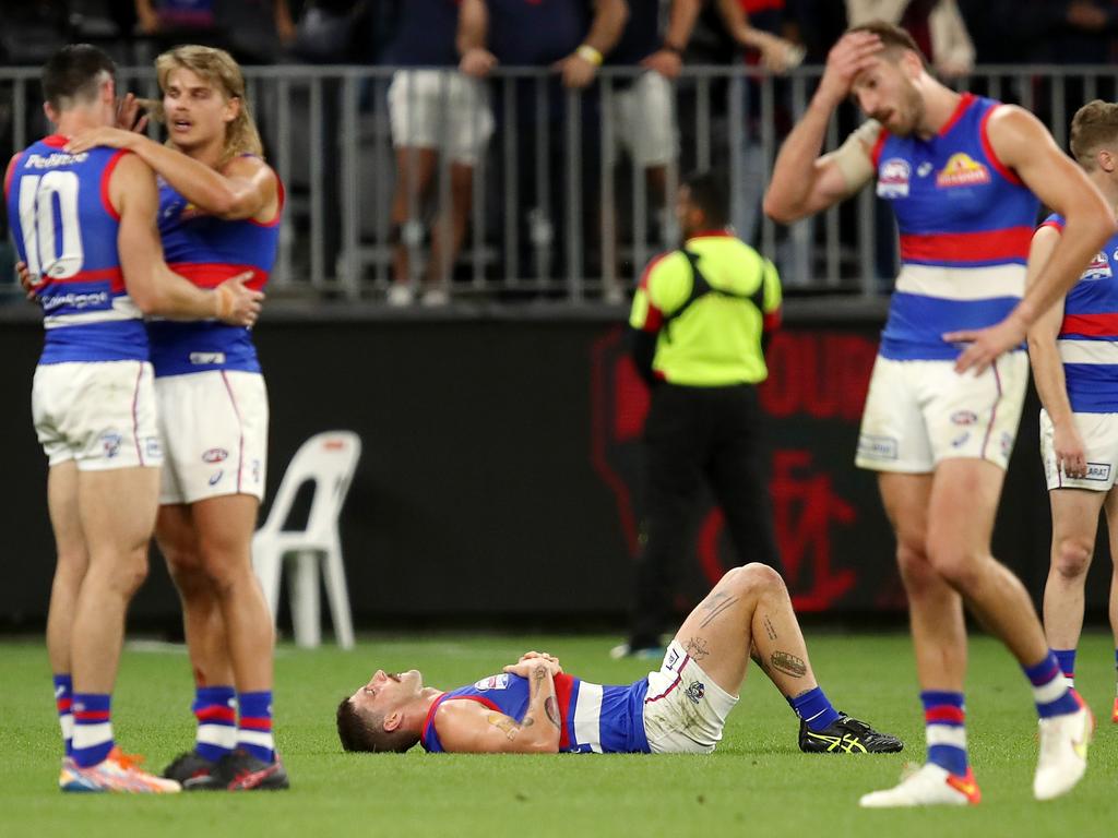 Bulldogs players look dejected at the final siren. Picture: Gary Day/AFL Photos via Getty Images