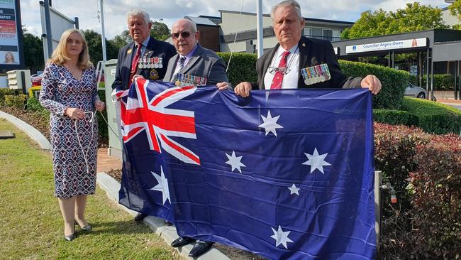 Australian flag outside Brisbane City Councillor Angela Owen's Calamvale office. Pictured: Cr Owen and veterans, including Harry Claassen.