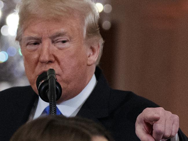 President Donald Trump watches as a White House aide reaches to take away a microphone from CNN journalist Jim Acosta during a news conference in the East Room of the White House, Wednesday, Nov. 7, 2018, in Washington. (AP Photo/Evan Vucci)