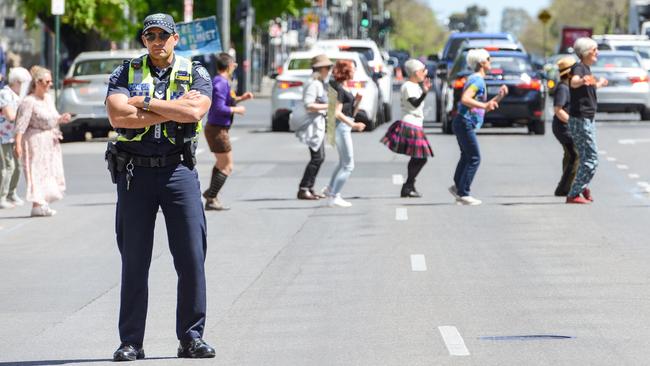 Extinction Rebellion dance to Nutbush City Limits in Flinders St today. Picture: AAP Image/Brenton Edwards