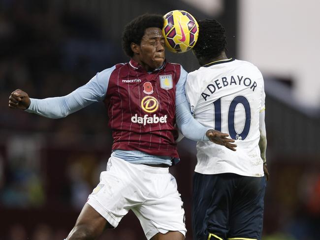 Aston Villa's midfielder Carlos Sanchez (left) jumps for the ball with Tottenham Hotspur's striker Emmanuel Adebayor during a match at Villa Park in Birmingham. Picture: AFP/Adrian Dennis