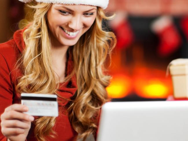 A happy woman buying Christmas presents online to complete her shopping list. Picture: iStock.