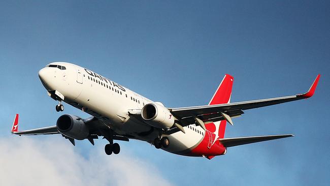 An Qantas passenger jet flies through stormy skies. The Australian aviation industry has hit turbulence since the outbreak of the COVID-19 coronavirus, with passenger numbers falling dramatically with statewide lockdowns and border closures. Picture: Brendan Radke