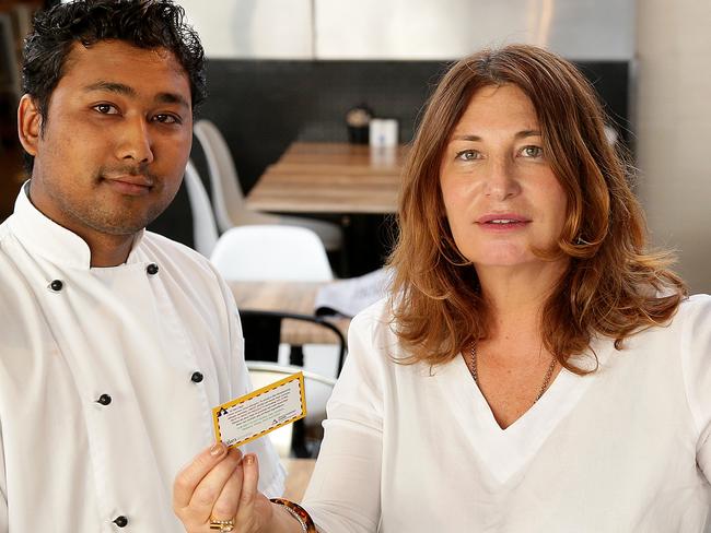 Janelle Williams hands a mammalian meat allergy card to Ground Zero chef Bijay Shrestha. Janelle has mammalian meat allergy caused by a tick bite. She is supporting the new chef card which explains what the allergy is to people in the food industry - to help save lives. Picture: Troy Snook