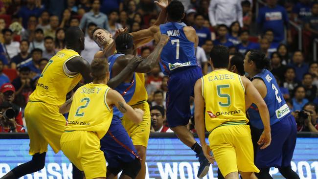 Jason William jumps to hit Australia’s Daniel Kickert. Picture: AP Photo