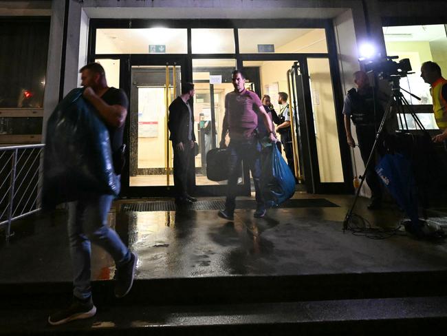 Police officers carry evidence out of a refugee hostel in Solingen, western Germany. Picture: AFP