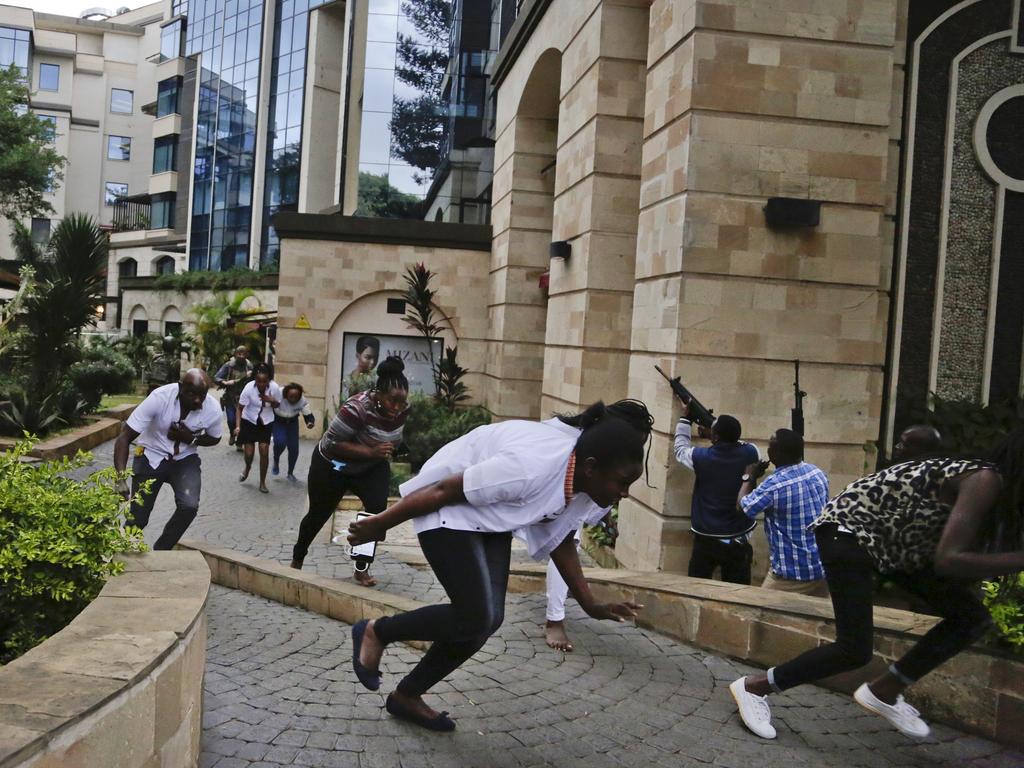 Civilians flee as security forces aim their weapons at the buildings of a hotel complex in Nairobi, Kenya. Picture: AP Photo/Khalil Senosi