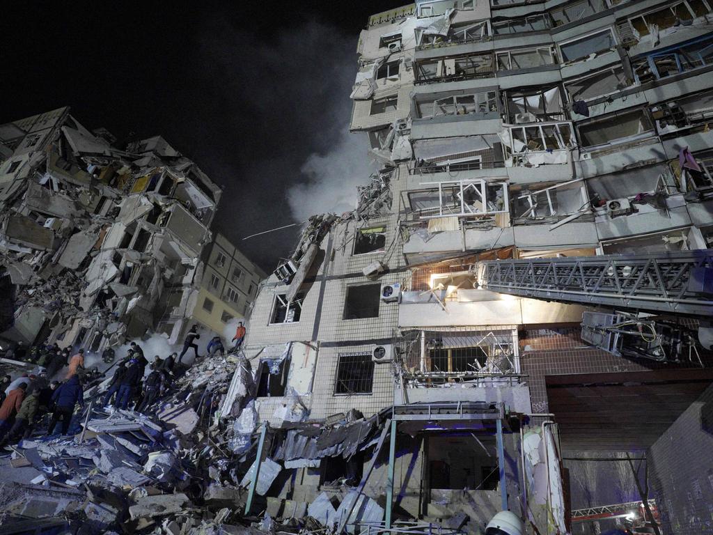 Rescuers works on a residential building destroyed after a missile strike, in Dnipro on January 14, 2023. Picture: AFP