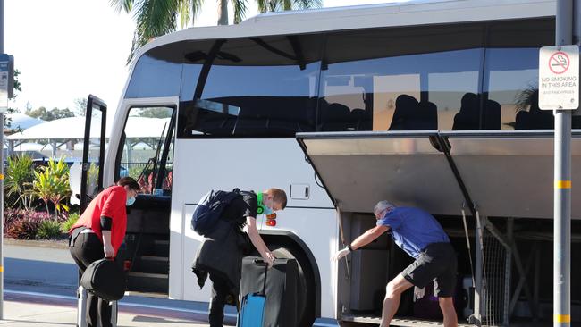 Passengers who arrived on a plane from Melbourne leaving the Gold Coast Airport on a bus taking them to quarantine. Picture: Glenn Hampson.