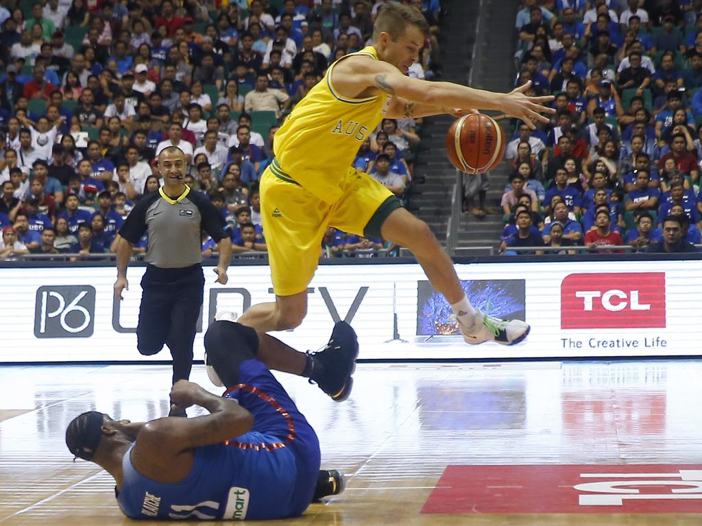 Australia's Nathan Sobey jumps over the Philippines' Andray Blache during the FIBA World Cup Qualifiers Monday, July 2, 2018 at the Philippine Arena in suburban Bocaue township, Bulacan province north of Manila, Philippines. Australia defeated the Philippines 89-53 via default following a brawl in the third quarter. (AP Photo/Bullit Marquez)