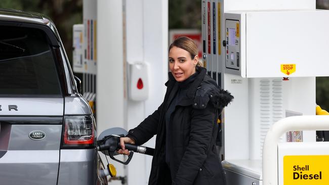 Stacey Papas fills up her car at a petrol station in Templestowe. Picture: Ian Currie