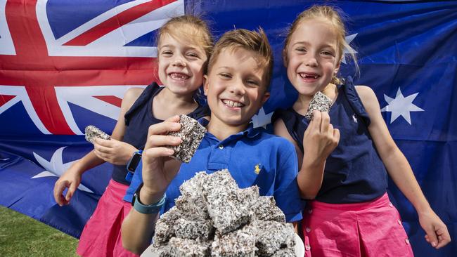 Cash Comiskey and his twin sisters, Chloe and Cienna, get ready for this year’s Lamington Eating Competition at the Sandstone Point Hotel on Australia Day. Picture: Lachie Millard.