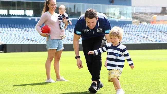 Patrick Dangerfield kicks the footy with his family, wife Mardi and kids Felicity and George.