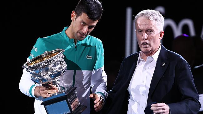 MELBOURNE, AUSTRALIA - FEBRUARY 21: Novak Djokovic of Serbia speaks with CEO of Tennis Australia Craig Tiley as he holds the Norman Brookes Challenge Cup following victory in his MenÃ¢â¬â¢s Singles Final match against Daniil Medvedev of Russia  during day 14 of the 2021 Australian Open at Melbourne Park on February 21, 2021 in Melbourne, Australia. (Photo by Cameron Spencer/Getty Images)