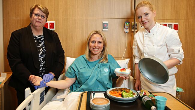 Left to right: Director of Nursing Moran Wasson, reporter Julie Cross as a volunteer fake patient and Executive Chef Lynsey Lappin at the Northern Beaches Hospital before it opened. Picture: Adam Yip.