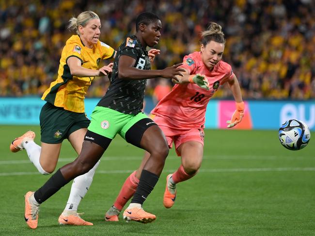 Nigeria striker Asisat Oshoala goes past Alanna Kennedy and Mackenzie Arnold on her way to scoring her team's third goal. Picture: Justin Setterfield/Getty Images