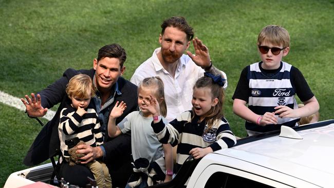 Retirees Tom Hawkins and Zach Tuohy of the Cats ride in the retiring players motorcade with their kids during the 2024 AFL Grand Final. Picture: Adam Trafford/AFL Photos via Getty Images