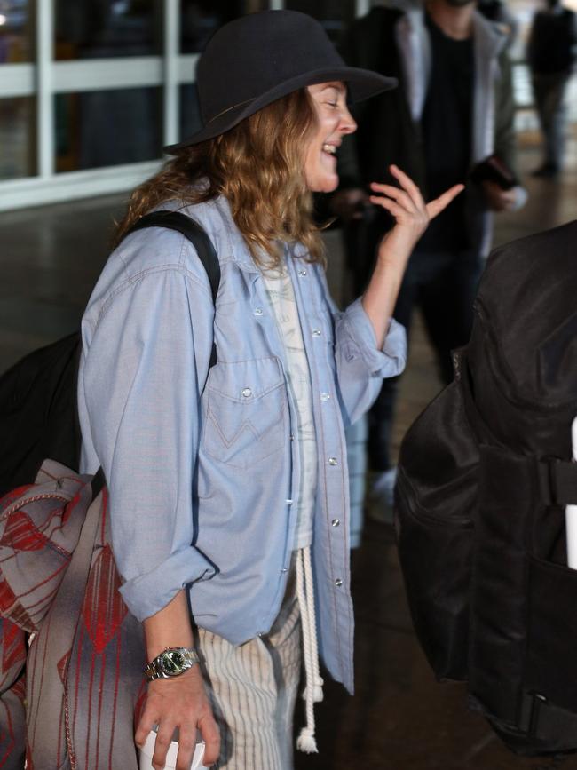 Drew Barrymore chats outside the airport. Picture: Matrix