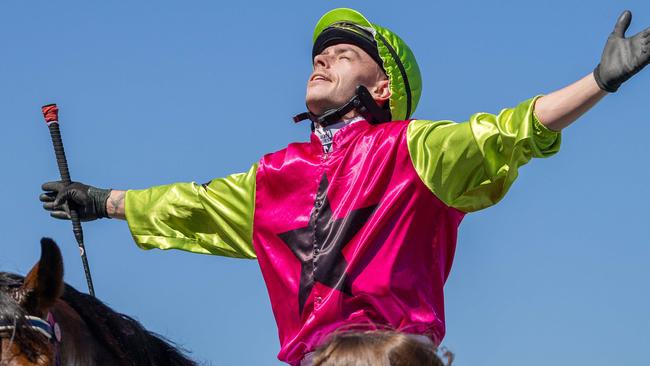 Robbie Dolan celebrates his Melbourne Cup victory aboard Knight’s Choice as he comes back to scale at Flemington. Picture: Jason Edwards