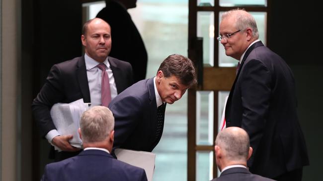 Josh Frydenberg and Scott Morrison see the lighter side of Energy Minister Angus Taylor’s predicament at the end of question time on Tuesday. Picture: Kym Smith